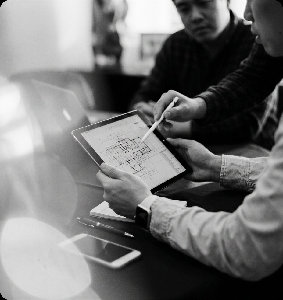 Industrial team reviewing drawings on a tablet